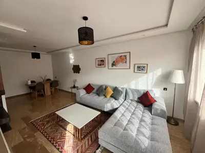 a living room with a couch and a table at Apartment Dar Bouazza with swimming pools and 2 bedrooms in Casablanca