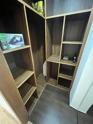 a closet with wooden shelves in a room at Apartment Dar Bouazza with swimming pools and 2 bedrooms in Casablanca