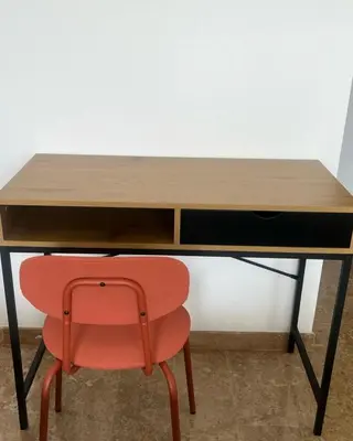 a desk with a red chair in front of it at Apartment Dar Bouazza with swimming pools and 2 bedrooms in Casablanca