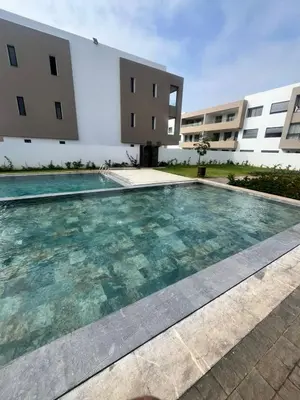 a swimming pool in front of a building at Apartment Dar Bouazza with swimming pools and 2 bedrooms in Casablanca