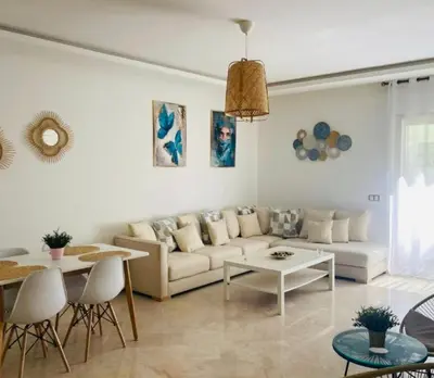 a living room with a couch and a table at Cozy studio with terrace - Mohammedia Center in Mohammedia