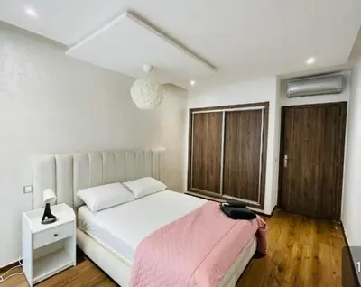 a bedroom with a white bed and a window at Cozy studio with terrace - Mohammedia Center in Mohammedia