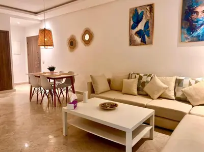 a living room with a couch and a table at Cozy studio with terrace - Mohammedia Center in Mohammedia
