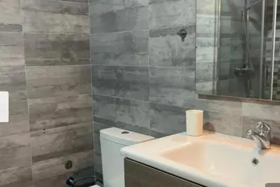 a bathroom with a toilet and a sink and a mirror at Cozy studio with terrace - Mohammedia Center in Mohammedia