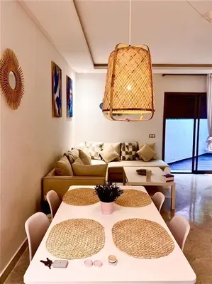 a living room with a table and a couch at Cozy studio with terrace - Mohammedia Center in Mohammedia