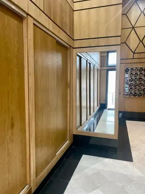 a hallway of a building with wooden walls and a glass door at Cozy studio with terrace - Mohammedia Center in Mohammedia