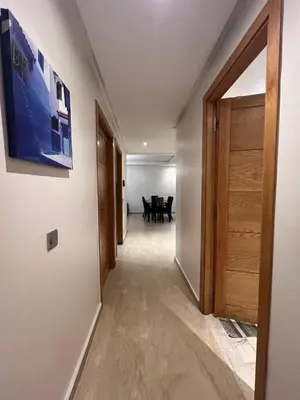 a hallway with a door leading to a dining room at Appartement spacieux tout confort in Casablanca