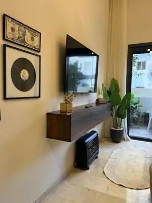 a living room with a flat screen tv on a wall at A Suites in Casablanca