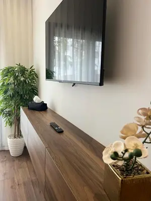 a living room with a tv on the wall at A Suites in Casablanca
