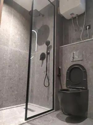 a bathroom with a shower with a black toilet at Studio haut standing in Casablanca