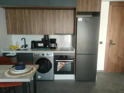 a kitchen with a stainless steel refrigerator and a dishwasher at Studio haut standing in Casablanca