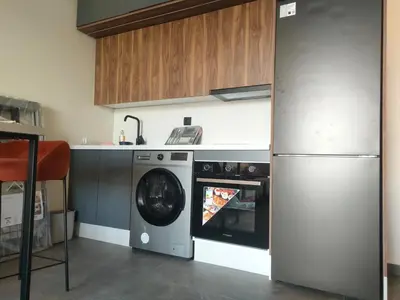 a kitchen with a washing machine and a refrigerator at Studio haut standing in Casablanca