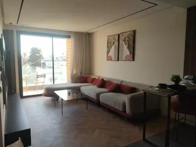 a living room with a couch and a large window at Studio haut standing in Casablanca
