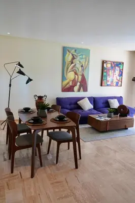 a living room with a table and a blue couch at Casablanca Finance City 2Bdr in Casablanca
