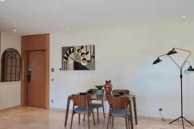 a dining room with a table and some chairs at Casablanca Finance City 2Bdr in Casablanca