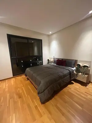 a bedroom with a large bed and a wooden floor at Casablanca Finance City 2Bdr in Casablanca