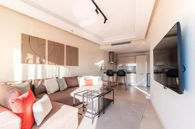 a living room with a couch and a table at Urban Escape Designer Apartment with Balcony in Casablanca
