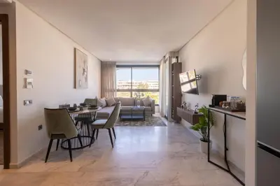 a living room with a table and a couch at Modern Studio in Maarif 16 with Free Private Parking in Casablanca