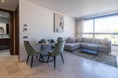 a living room with a couch and a table at Modern Studio in Maarif 16 with Free Private Parking in Casablanca
