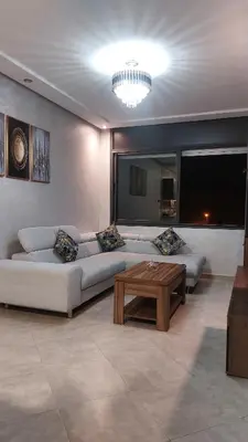 a living room with a couch and a coffee table at Cozy studio Avec Piscine in Bouznika