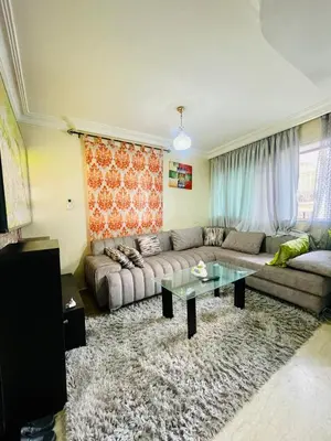 a living room with a couch and a table at Résidence TPM in Casablanca