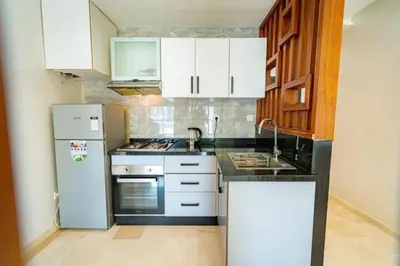 a kitchen with white cabinets and a stainless steel refrigerator at Studio in Casablanca