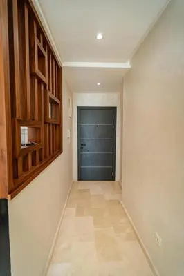a hallway with a garage with a door and a tile floor at Studio in Casablanca