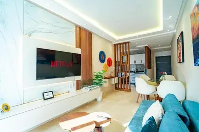 a living room with a blue couch and a television at Studio in Casablanca