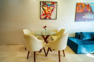 a living room with a glass table and chairs at Studio in Casablanca
