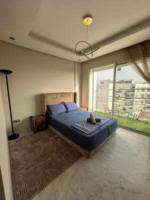 a bedroom with a bed and a large window at Hay Riad Sunset Studio Stadium View , 5 mind a pied stade moulay abdelah in Rabat