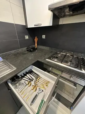 a kitchen with a counter with utensils and a stove at Hay Riad Sunset Studio Stadium View , 5 mind a pied stade moulay abdelah in Rabat