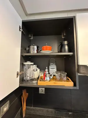 a kitchen with a wooden cutting board on a shelf at Hay Riad Sunset Studio Stadium View , 5 mind a pied stade moulay abdelah in Rabat
