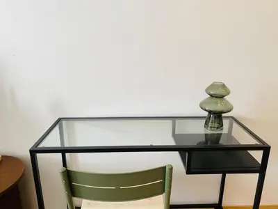a glass table with a green chair under it at Welcome Stay Centre Casa Gares &Tram in Casablanca