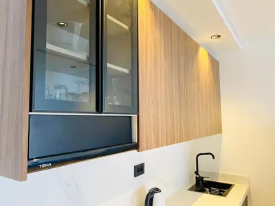 a kitchen with wooden cabinets and a sink at Welcome Stay Centre Casa Gares &Tram in Casablanca