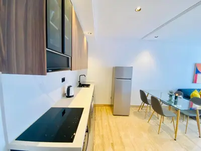 a kitchen with a table and chairs and a refrigerator at Welcome Stay Centre Casa Gares &Tram in Casablanca