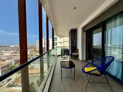 a balcony with two chairs and a table on a building at Beau studio a CFC in Casablanca