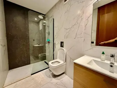 a bathroom with a toilet and a shower and a sink at Beau studio a CFC in Casablanca