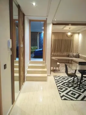 a living room with a couch and a table at Beautiful apartment in Hay Al Qods Bernoussi in Casablanca