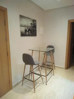 two chairs and a glass table in a room at Beautiful apartment in Hay Al Qods Bernoussi in Casablanca