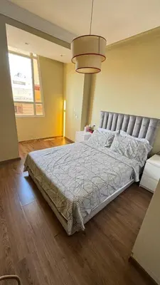 a bedroom with a large bed in a room at Appartement meublé à HARHOURA in Temara