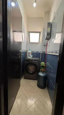 a small bathroom with a washing machine in it at Appartement meublé à HARHOURA in Temara