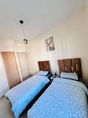 two beds sitting next to each other in a bedroom at Elegant house for you in Ain Sebaa 4 in Casablanca