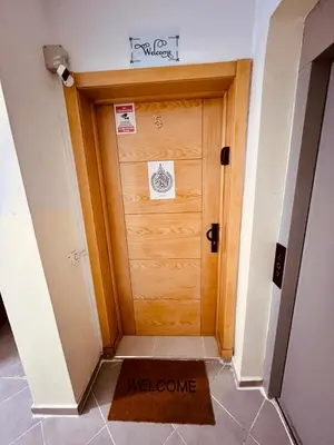 a welcome mat in front of a wooden door at Elegant house for you in Ain Sebaa 4 in Casablanca