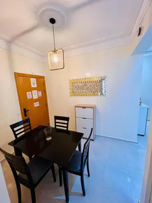 a dining room with a black table and chairs at Elegant house for you in Ain Sebaa 4 in Casablanca