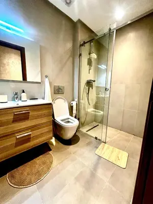 a bathroom with a shower and a toilet and a sink at Charming Studio in Zenata Eco-city, Pool and Sea View in Aïn Harrouda