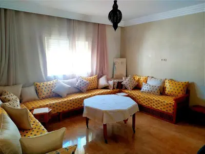 a living room with a couch and a table at Elegant apartment with sea view in Rabat
