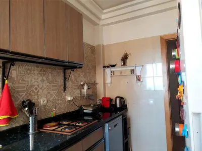 a kitchen with a stove and a counter top at Elegant apartment with sea view in Rabat