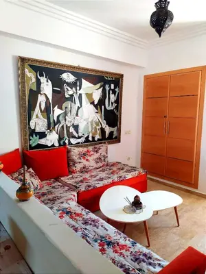 a living room with a couch and a table at Elegant apartment with sea view in Rabat