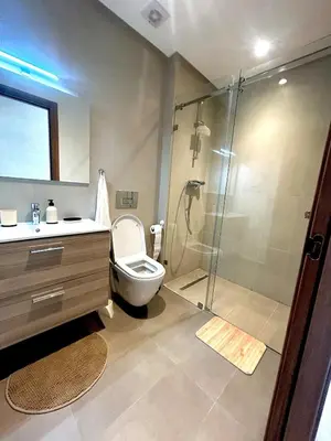 a bathroom with a shower and a toilet and a sink at Luxury Studio in a secured residence in Aïn Harrouda
