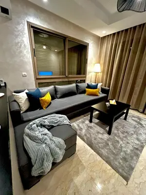 a living room with a couch and a table at Luxury Studio in a secured residence in Aïn Harrouda